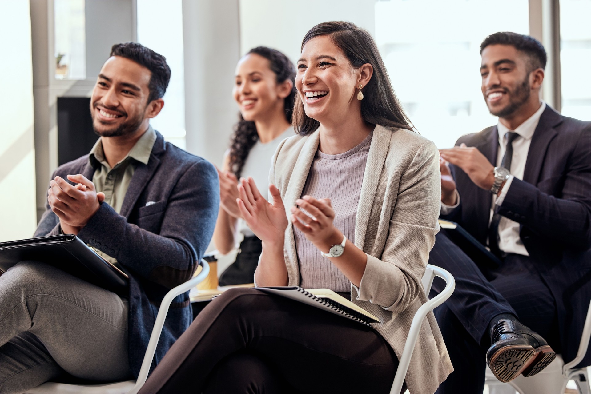Shot of a group of businesspeople clapping hands in a meeting at work